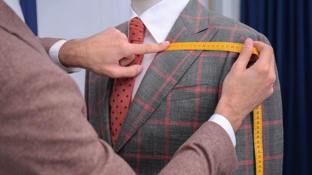 Custom suit tailor taking measurement